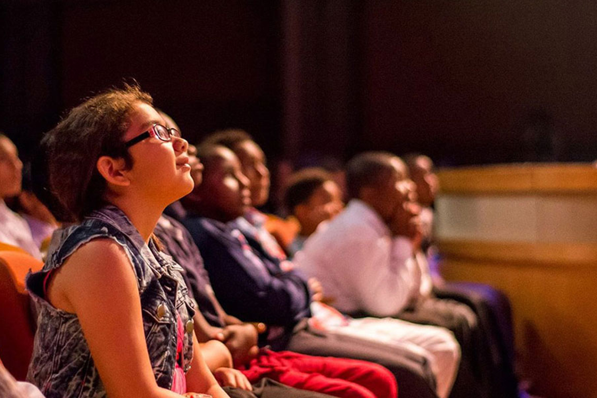 People in a theater looking at the stage | The Miami Foundation