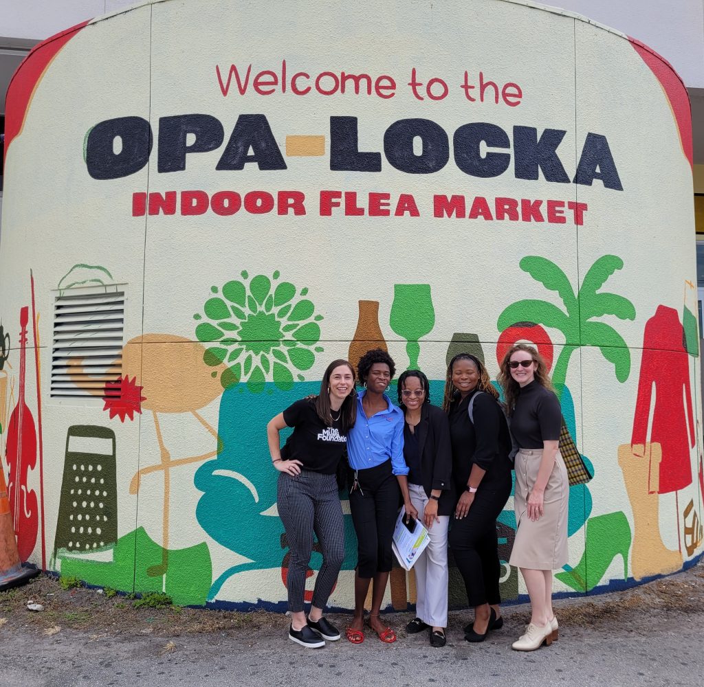 People standing in front of the Opa Locka Flea Market