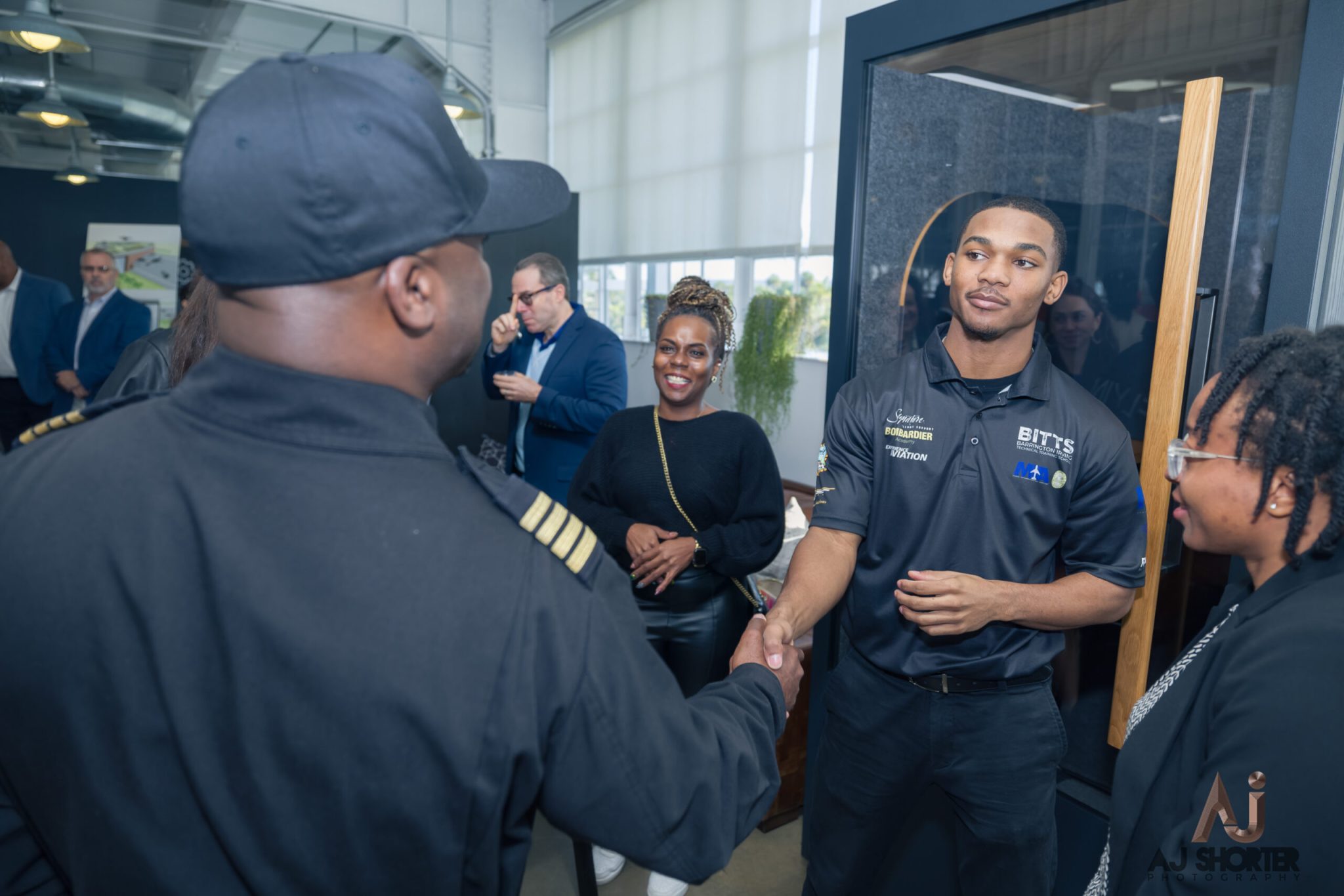 Sommer Curry, son Vontre, Brenda Morrison, and Captain Irving at the first ever graduation for the Barrington Irving Technical Training School (BITTS)
