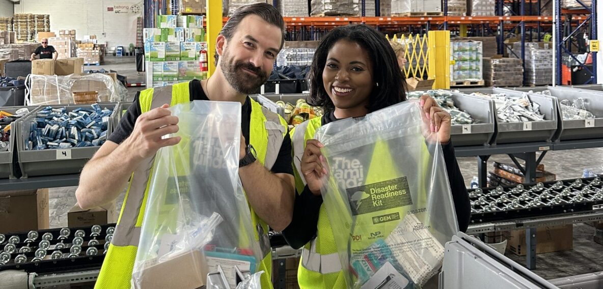 Two people holding up The Miami Foundation Disaster Readiness Kits