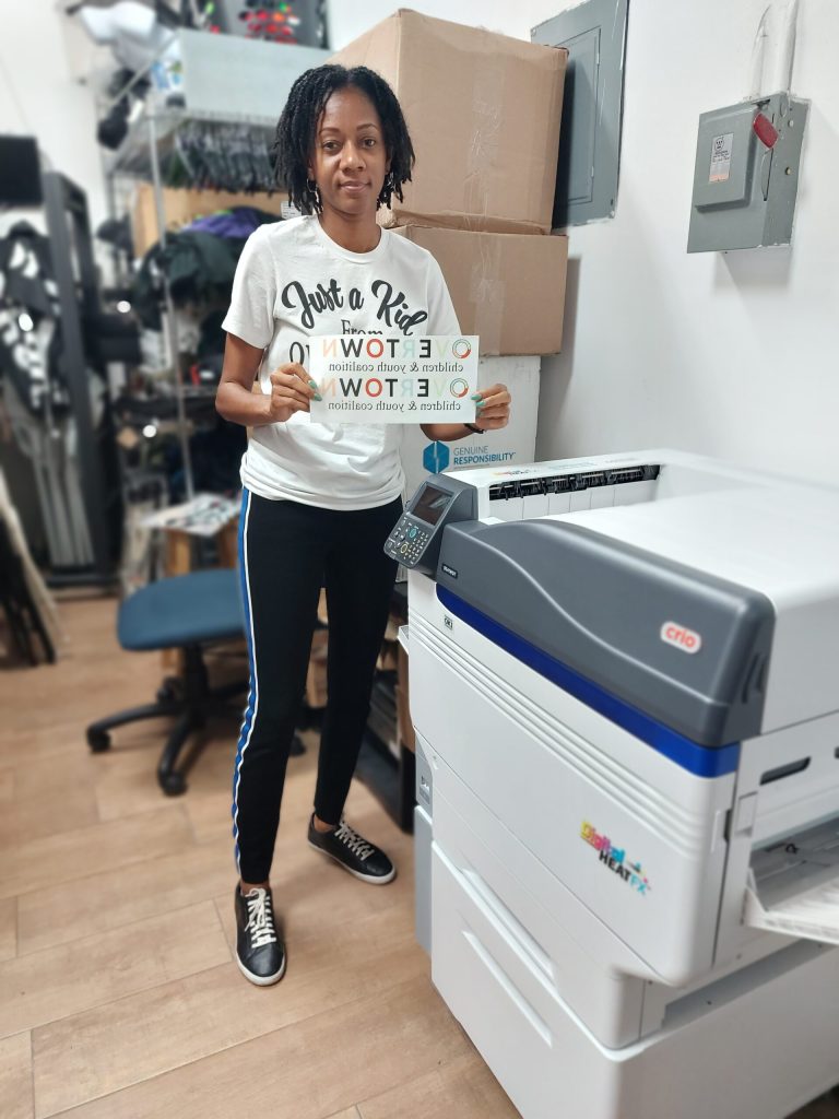 Pictured: Ultrina showcasing the Direct to Transfer Machine that she purchased with OFB Funding.